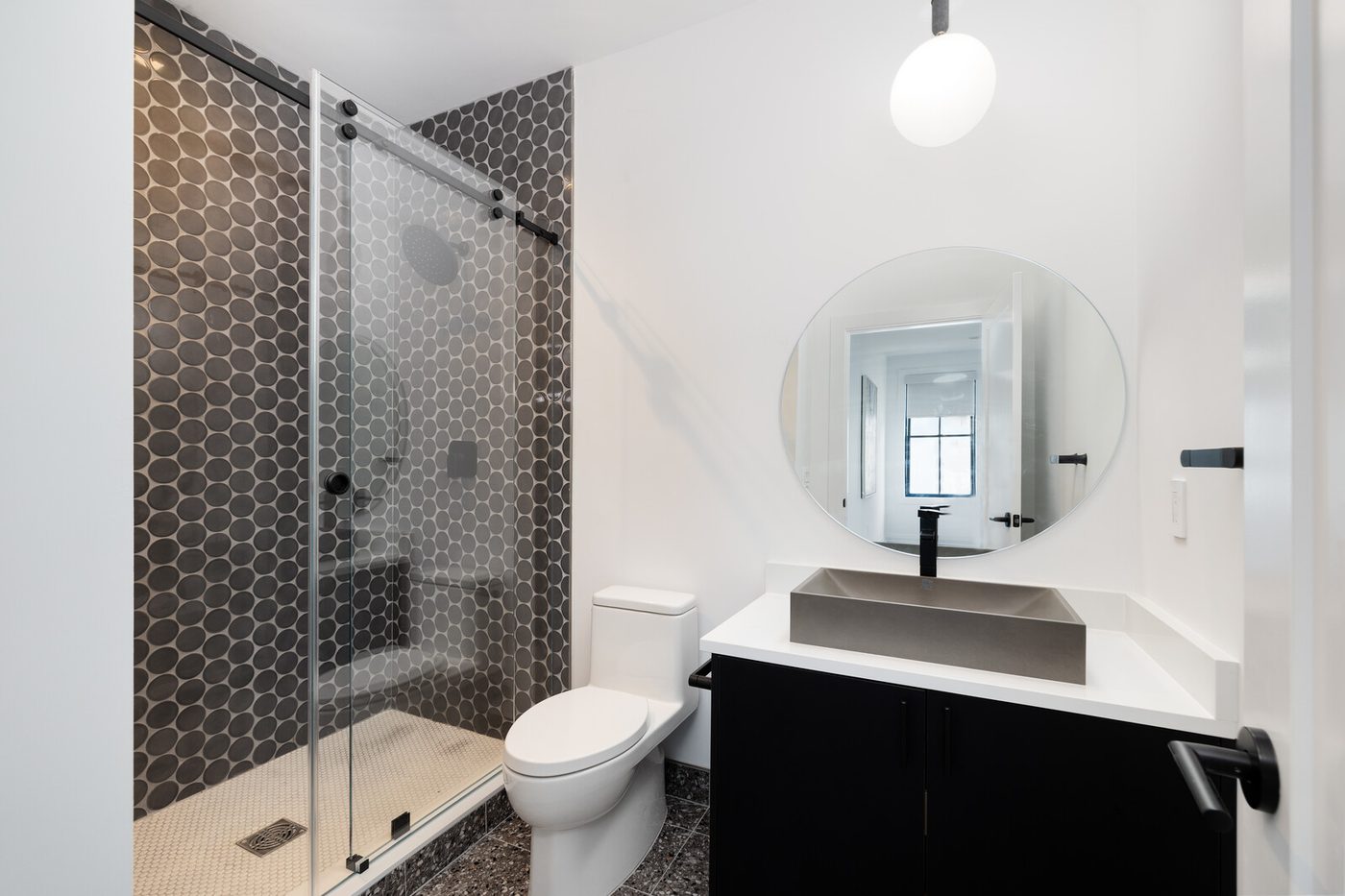 Bathroom with glass shower and vanity lighting